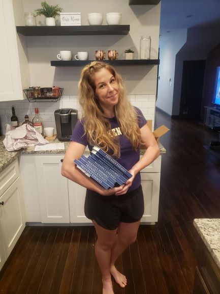 Dr. Lauren Thompson, FSU History Alumna, holding copies of her recently published book.